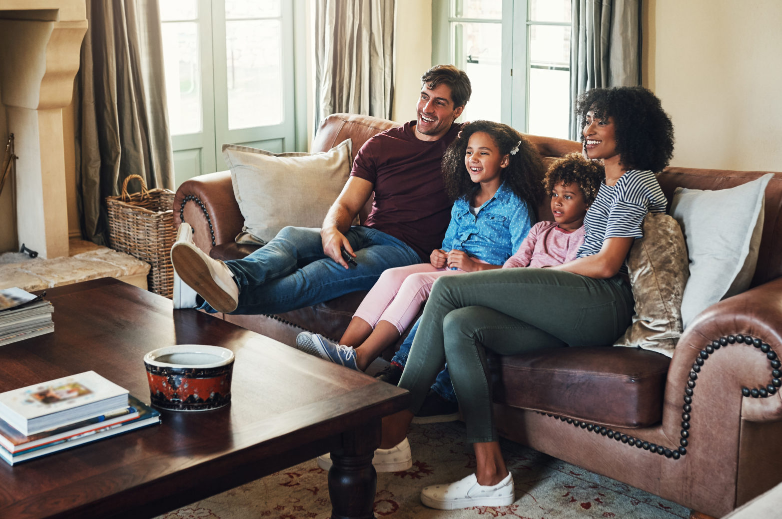 Family watching tv together in living room