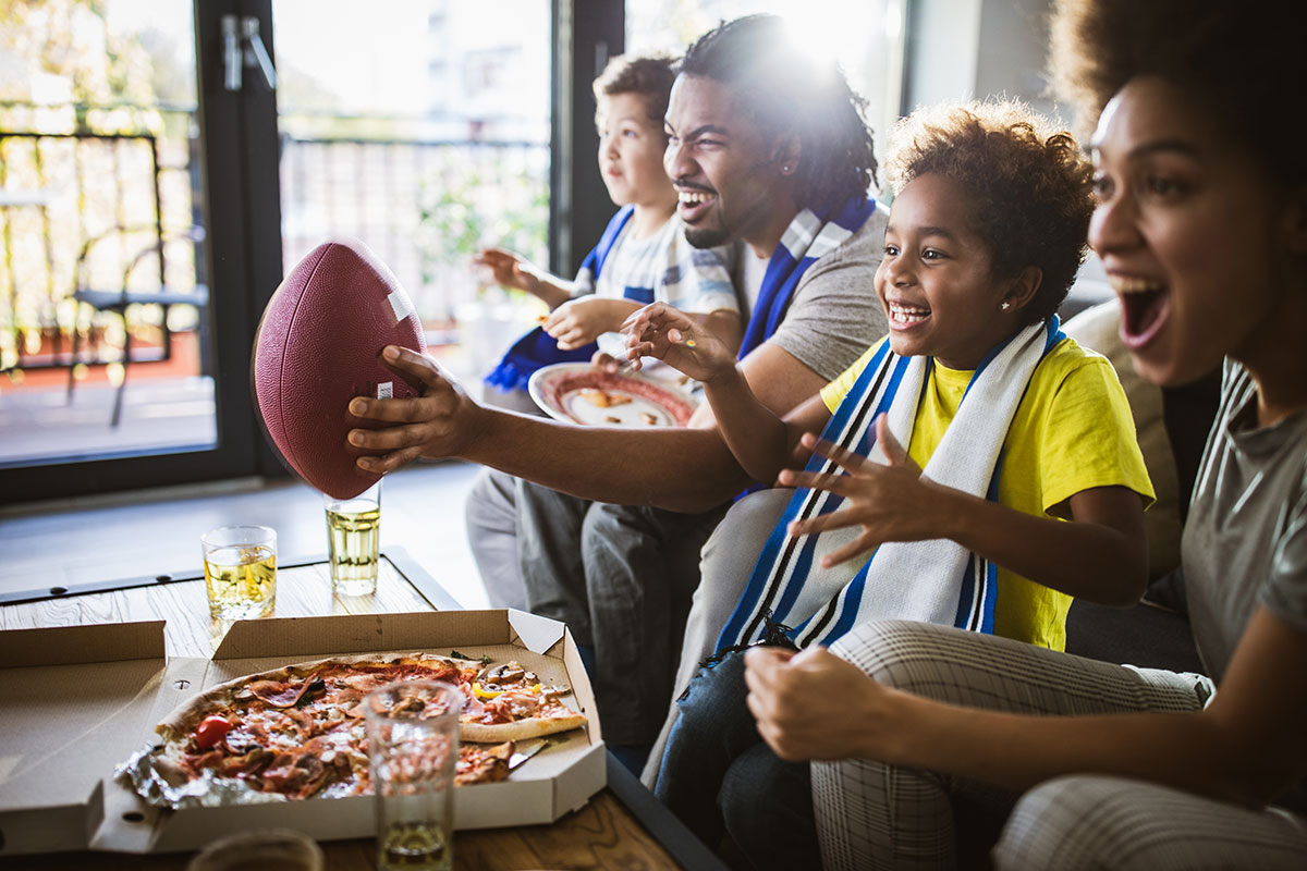 A group of people watching a football game