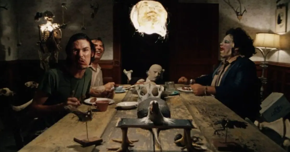 Image of the dinner table scene from The Texas Chain Saw Massacre (1974) showing the Sawyer family laughing and mocking Sally Hardesty (not shown).