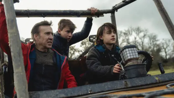 Image of a man and two boys driving a Jeep—a scene from Arcadian, streaming on Shudder in July 2024.