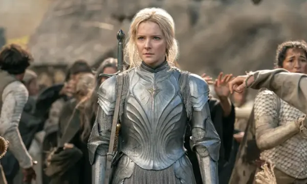 A young, blonde-haired elf woman in silver armor.